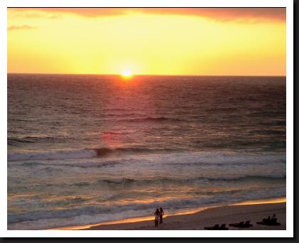 sunset on water with couple on panama city beach